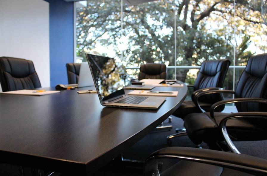conference table with laptop and files